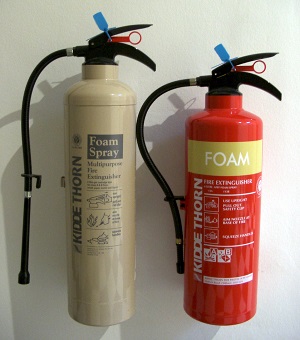 alt text: two fire extinguishers mounted to a wall